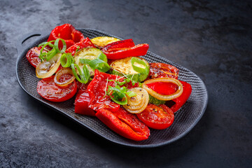 Modern style traditional barbecue vegetable with onion rings and herb served as side dish on a...
