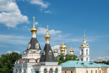 Architectural ensemble "Dmitrovsky Kremlin" on a sunny day, against the background of a blue sky with white, air clouds. Dmitrov. Russia.