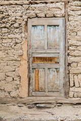 Wooden door in a traditional mud brick home.