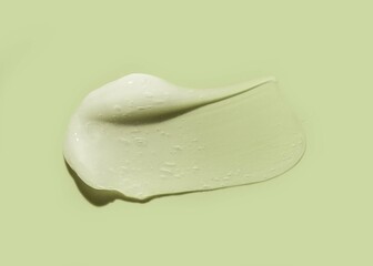 Cosmetic white gel or foam blurred texture green background