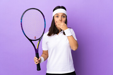 Young woman tennis player over isolated background covering mouth with hands