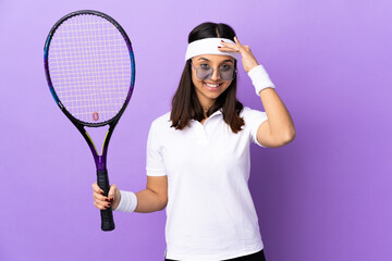 Young woman tennis player over isolated background saluting with hand with happy expression