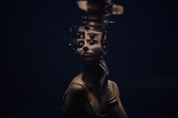 Fototapeta na wymiar Mermaid. Portrait of young beautiful woman underwater.