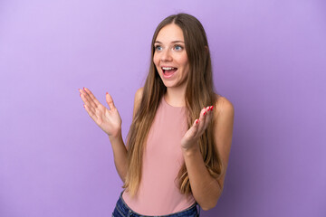 Young Lithuanian woman isolated on purple background with surprise facial expression