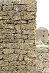 The fortress wall is made of natural stone. Ancient limestone stone. Creative vintage background. Ukraine. Belgorod - Dnestrovsky.