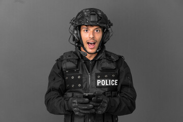 SWAT caucasian man isolated on grey background surprised and sending a message