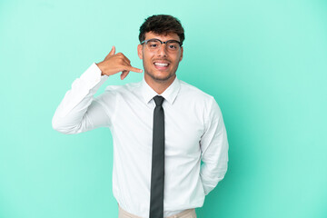 Business caucasian man isolated on blue background making phone gesture. Call me back sign