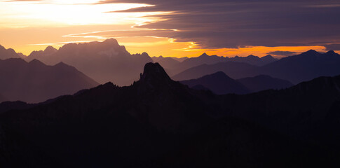 Mountain sunset, pre alps mountains. sun rays emerging though the dark storm clouds in the mountains. zugspitze wallberg germany landscapes.