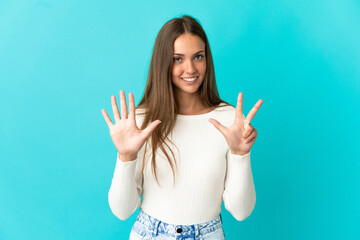 Young woman over isolated blue background counting eight with fingers