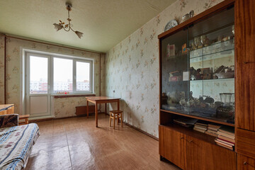 Example of Old Soviet Russian poor interior in Leningrad project House. Aged  sideboard, table,...