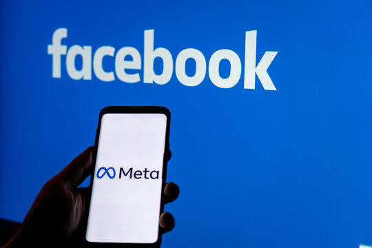 Moscow, Russia - Oct 30 2021: Social media platform will change to Meta to emphasize its metaverse vision.. Smartphone with Meta logo on background of Facebook logo. Renaming and rebranding