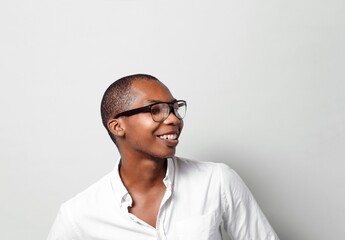 Obraz premium Head shot with copy space of a cheerful black man happy with glasses looking away.