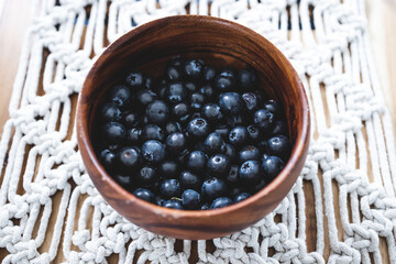close-up of blueberries in wooden bowl, simple ingredients concept