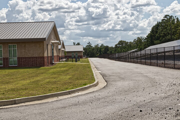 Rows of Solar panels behind a fence and buildings in Georgia