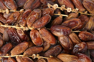 Sweet dried dates on branches as background, top view. Healthy snack