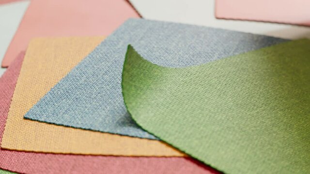 Animation with a set of fabric samples. Square pieces of multiclour materials.