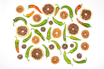 hot green peppers and dried citrus fruit on a white background. grocery organic flatley