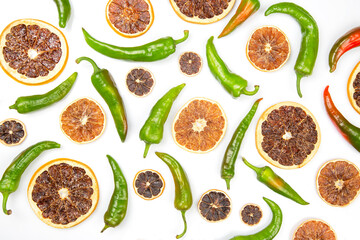 hot green peppers and dried citrus fruit on a white background. grocery organic flatley