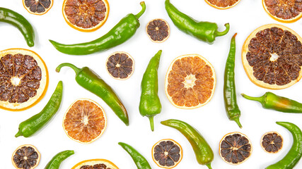hot green peppers and dried citrus fruit on a white background. grocery organic flatley