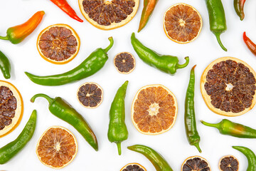 hot green peppers and dried citrus fruit on a white background. grocery organic flatley