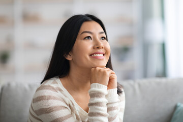 Portrait Of Dreamy Young Beautiful Asian Lady Relaxing In Domestic Interior
