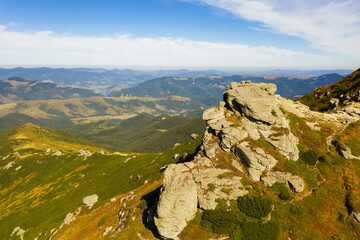 Fototapeta premium Beautiful view of rocky peak in mountains on sunny day. Drone photography