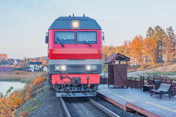 Highspeed train stands by the wooden platform at sunset. Sortavala. Republic of Karelia.