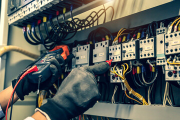 Electricity and electrical maintenance service, Close-up circuit breaker has engineer using...