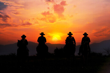 Cowboy silhouette on horseback with mountain view and sunset sky. - 466073092