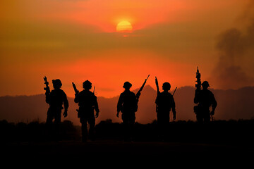 Fototapeta na wymiar The silhouette of a military soldier with the sun as a Marine Corps for military operations