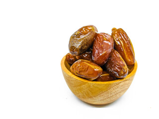 Fresh and healty premium honey tunisia dates (kurma tunisia) in a wooden bowl isolated on white background