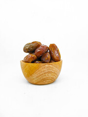Fresh and healty premium honey tunisia dates (kurma tunisia) in a wooden bowl isolated on white background
