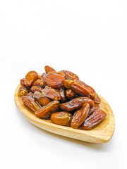 Fresh and healty premium honey tunisia dates (kurma tunisia) in a wooden bowl isolated on white background