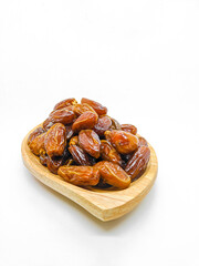 Fresh and healty premium honey tunisia dates (kurma tunisia) in a wooden bowl isolated on white background