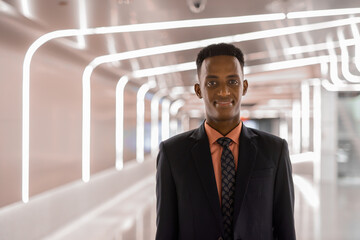 Portrait of successful young African businessman wearing suit and tie