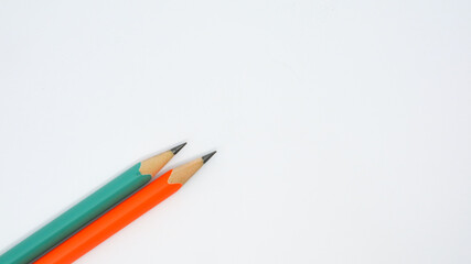 Pencils placed on white paper background with copy space for your image or text.