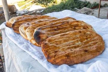 Asian bread baked in tendir. Selective focus - obrazy, fototapety, plakaty