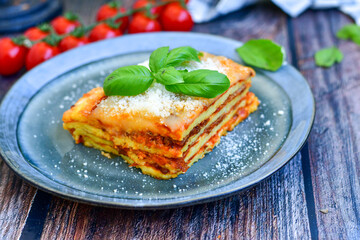   Delicious Home made  ketogenic Lasagna bolognese  with minced meat,tomato sauce and spinach  on a wooden rustic  background.Home made  keto diet italian meal