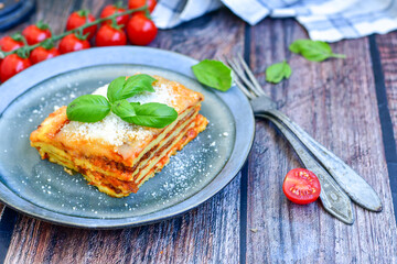   Delicious Home made  ketogenic Lasagna bolognese  with minced meat,tomato sauce and spinach  on a wooden rustic  background.Home made  keto diet italian meal