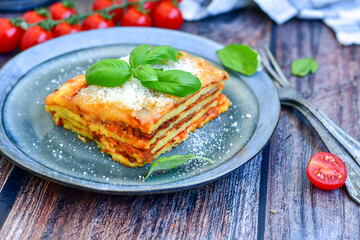   Delicious Home made  ketogenic Lasagna bolognese  with minced meat,tomato sauce and spinach  on a wooden rustic  background.Home made  keto diet italian meal