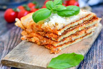   Delicious Home made  ketogenic Lasagna bolognese  with minced meat,tomato sauce and spinach  on a wooden rustic  background.Home made  keto diet italian meal