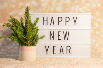 Happy New Year displayed on vintage lightbox with eco tree New Years Eve, concept image