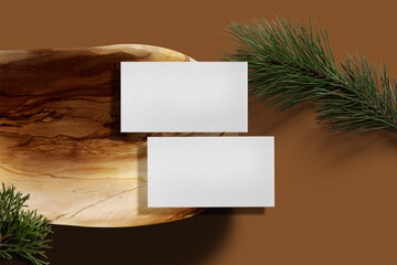 Clean minimal business card mockup on wooden plate with conifer