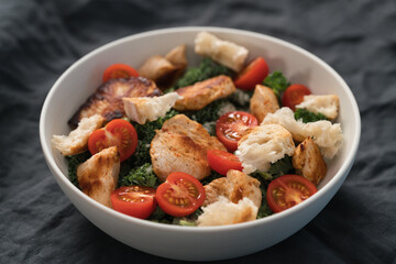 Caesar salad alternative with kale and turkey in white bowl