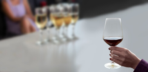 hand holding wine glass in vineyard
