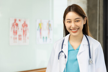 Confident young Asia female doctor in white medical uniform with stethoscope looking at camera and smiling  health hospital.Portrait of a smiling doctor in office.