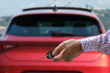 hand holding car key, selective focus