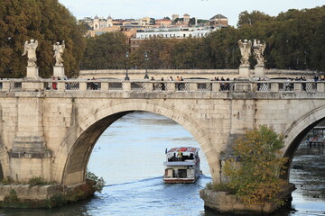 Ponte Sant'Angelo Bridge Detail with Passing Boat in the Tiber River in Rome, Italy
