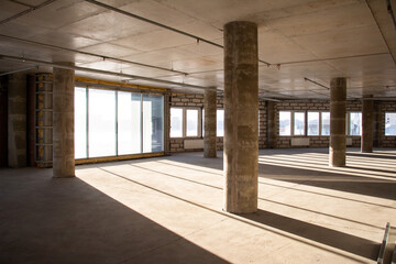 Empty full of light hall with columns before repair and renovation