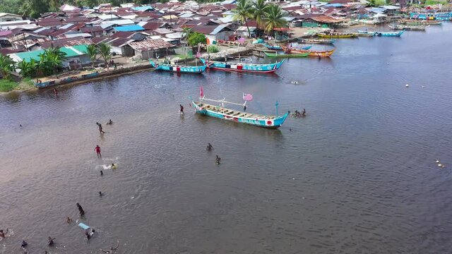 Aerial poor African fishing village Liberia Africa. West Africa country dark history Civil wars, Ebola and COVID and economic failures stagnated economic growth. Poverty, no jobs or industry.